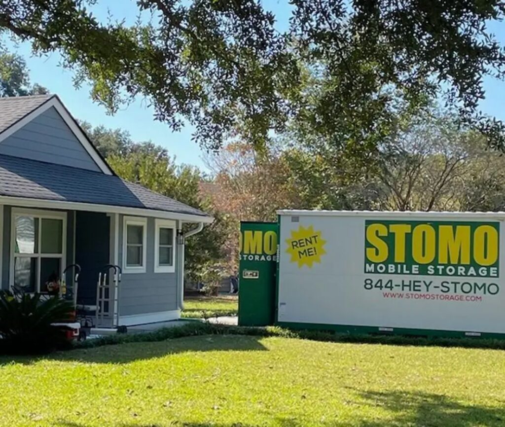 Family using mobile storage container in driveway