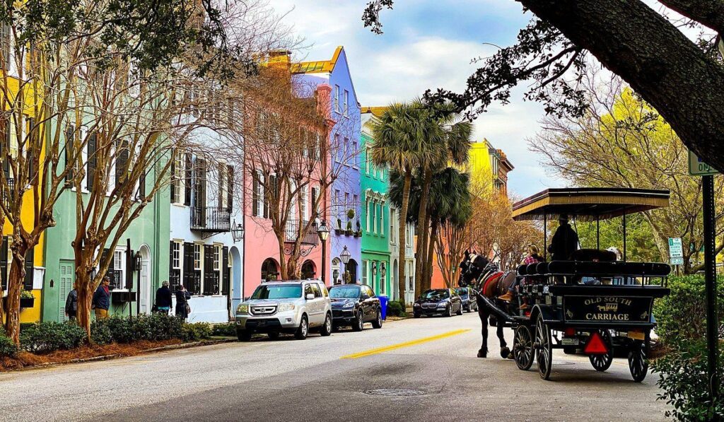 People moving boxes in Charleston with storage truck labeled Storage Solutions