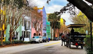 People moving boxes in Charleston with storage truck labeled Storage Solutions