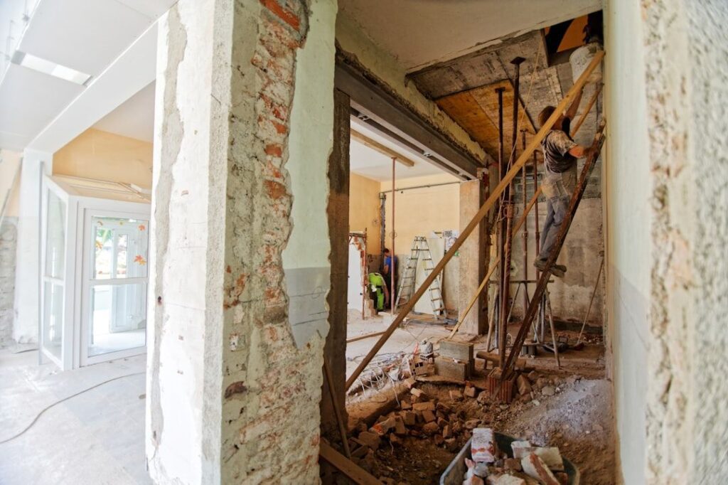Family and contractor planning a home renovation with 'Smart Solutions' on a tablet