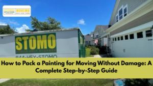 Person carefully packing a framed painting for moving using protective materials.